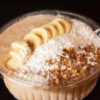 Coconut Bowl · Blended coconut pulp topped with bananas, granola and coconut flakes.