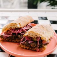 Brisket Sandwich · slow-cooked brisket, coconut curry slaw, toasted stirato.