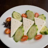 Feta Cheese Platter (3 Pcs) · Sliced feta cheese, served with black olives, tomato and cucumber.