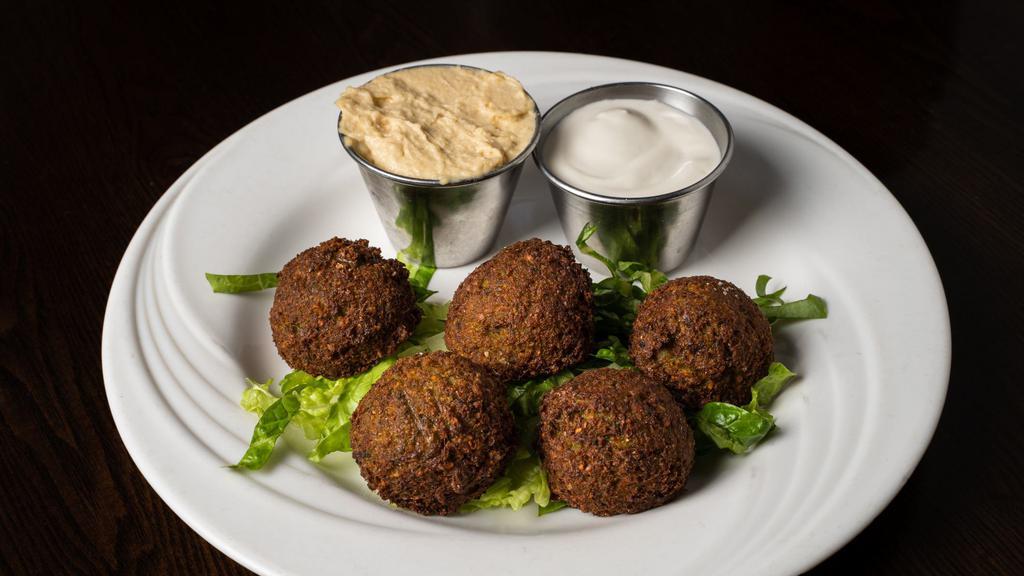 Falafel Plate (5 Pcs) · Deep fried chickpeas and vegetables, blended with Middle Eastern spices and tahini sauce on the side served with hummus.