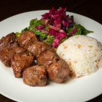 Lamb Shish Kebab · Marinated chunks of baby lamb grilled on skewers. Served with rice and house salad.