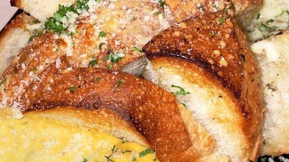 Pull Apart Bread · Bread stuffed with garlic butter and parmesan cheese filled with a cheese fondue cutout