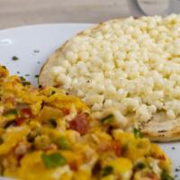 Huevos Al Gusto · Eggs any style with cheese topped arepa.