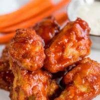Buffalo Wings (8) · Jumbo wings marinated with buffalo sauce served with Carrots, Celery & Blue Cheese.