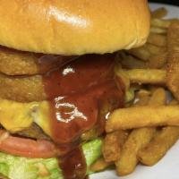 Jack Daniels Burger · Black Angus, lettuce, tomato, fried onion rings, cheese & drizzled with Jack Daniels BBQ sau...
