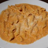 Penne A La Vodka · Penne tossed in vodka sauce topped
with Parmesan Cheese