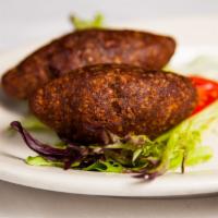 Kibbeh · Lebanese specialty pureed lamb with bulgar stuffed with toasted pinenuts and ground lamb.