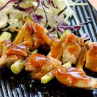Yakitori · Two skewers. Grilled seasoned chicken and scallion on skewers with teriyaki sauce.