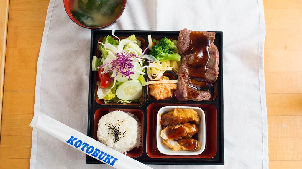 Steak Teriyaki Bento · baked steak served with chicken or tofu appetizer, rice, salad, in a traditional lunch box.