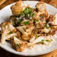 Cauliflower · Tossed with fresh oregano, jalapeño peppers, and red onion over tahini.