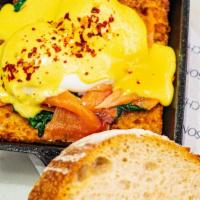 New Yorkers' Eggs Benedict · House-made jalapeño hash brown, hollandaise, pastrami spiced smoked salmon, baby spinach.