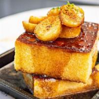 Pain Perdu - Royale French Toast · Royale baked brioche, banana, brown sugar & maple sauce, espelette pepper, lime.