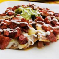 Nachos · Crispy tortilla chips topped with refried beans, melted cheese and cream. Served with guacam...