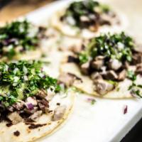 Grilled Steak Taco · With green sauce, cilantro and onions.