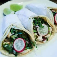 Grilled Chicken Taco · With green sauce, cilantro and onions.