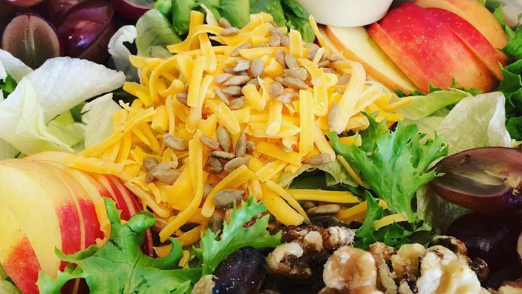 Angry Fruit Salad · Mixed greens topped with split red grapes, sunflower seeds, sliced apple, avocado, walnuts and shredded cheddar cheese.