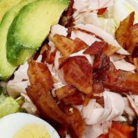 Cobb Salad · Mixed greens topped with roasted turkey, bacon, hard-boiled egg, cucumber, tomato and avocado.