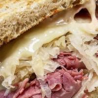 The Ellis Island Reuben - Whole Size · Hot corned beef, melted Swiss, sauerkraut and Russian dressing on toasted rye bread.