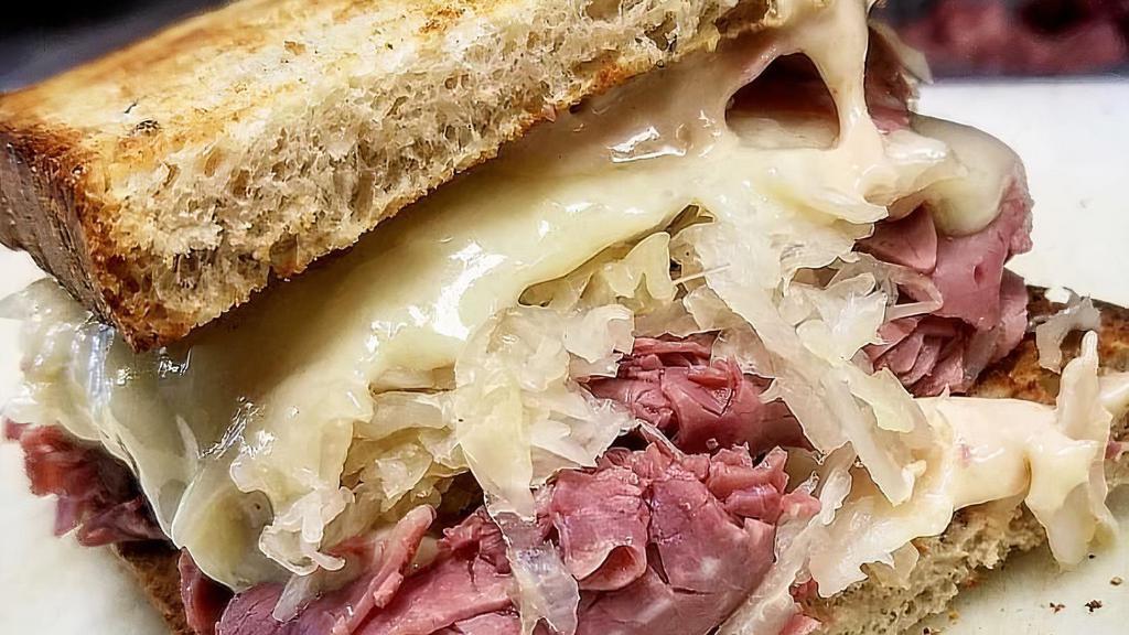 The Ellis Island Reuben - Whole Size · Hot corned beef, melted Swiss, sauerkraut and Russian dressing on toasted rye bread.