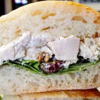 Leah'S Sunflower Chicken Salad Sandwich - Whole Size · Homemade chicken salad, lettuce, split grapes and sunflower seeds on stretch bread. *Stretch...