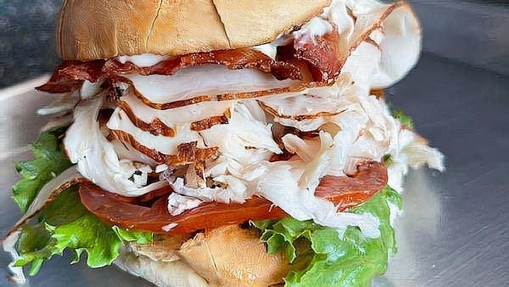 The Orange Pack - Whole Size · Club sandwich with your choice of roasted turkey or breaded chicken with bacon, lettuce, tomato and mayo on toasted homemade focaccia.