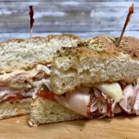 The Tribeca - Whole Size · Hot roast turkey, melted provolone, Italian tomatoes and Russian dressing on toasted focacci...