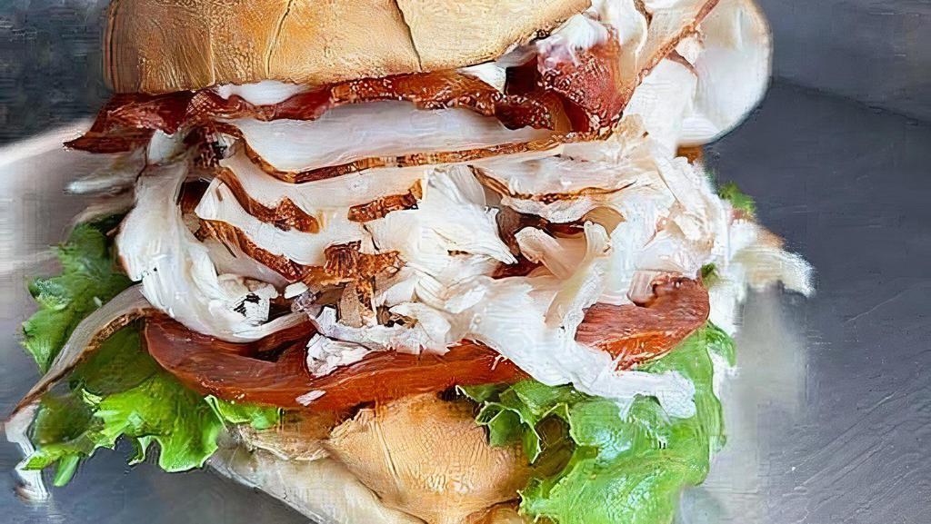 The Orange Pack - Half Size · Club sandwich with your choice of roasted turkey or breaded chicken with bacon, lettuce, tomato and mayo on toasted homemade focaccia.