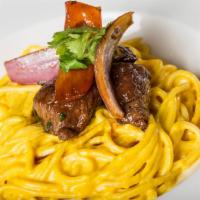 Tallarin A La Huancaina Con Lomito Saltado · Spaghetti in yellow Peruvian pepper sauce with pepper steak, onions tomatoes in oyster sauce...