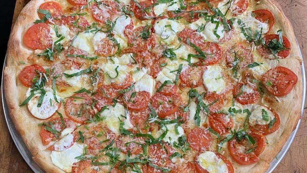 Sophia Loren Med · Fresh mozzarella, parmigiano-reggiano, marinated sliced tomatoes, garlic and basil.
