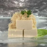 Traditional Japanese Hiyayako · Chilled tofu topped with bonito flakes, grated ginger, green onions, and served with soy sau...