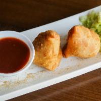 Samosa · Crispy pyramid stuffed with delicately spiced potatoes & peas served with tamarind sauce.