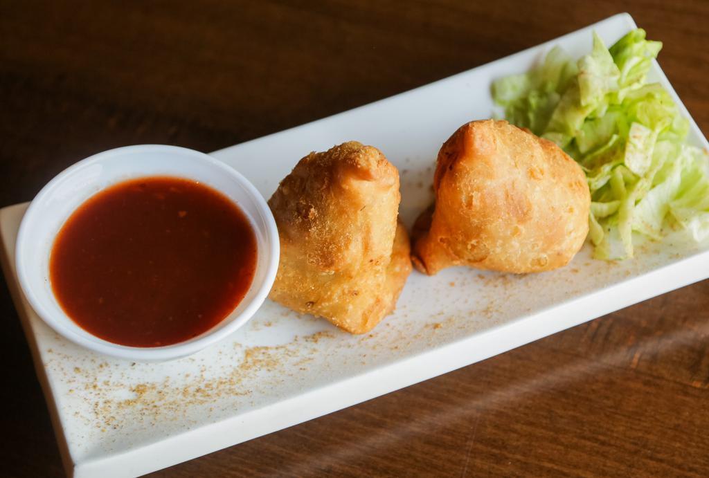 Samosa · Crispy pyramid stuffed with delicately spiced potatoes & peas served with tamarind sauce.