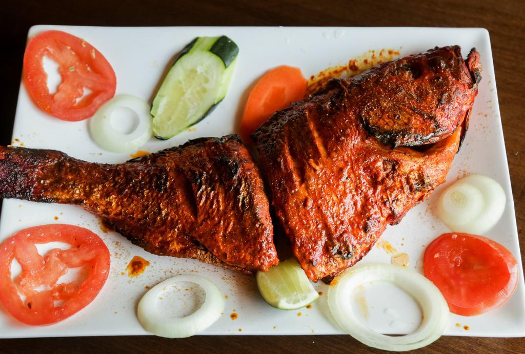 Tandoori Whole Fish · Whole trout broiled in clay oven & served with vegetables.