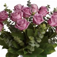 1 Dozen Purple Roses · 1 dozen premium purple roses embellished with baby's breathe, eucalyptus and greenery in a g...