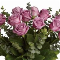 Dozen Of Purple Roses  · Long stems premium roses beautifully arrangedin a tall crystal vase and fillers