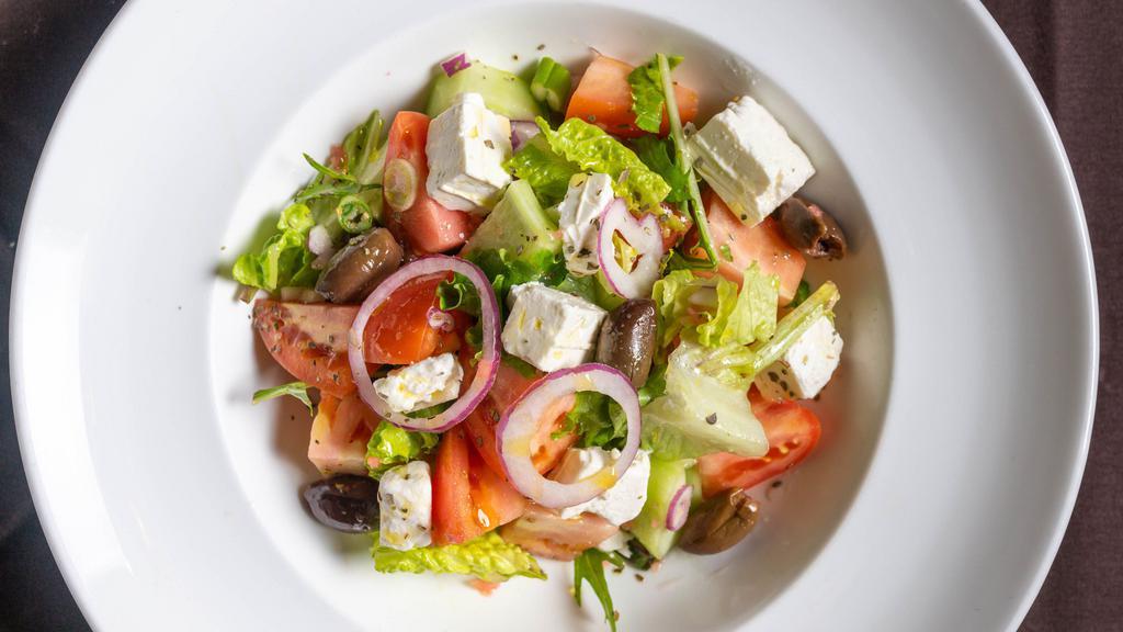 Traditional Greek Salad · Romaine lettuce, tomatoes, cucumbers, feta cheese, red onions, kalamata olives & extra virgin olive oil vinaigrette.