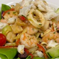 Marinated Seafood Salad · A combination of shrimp, scallops, calamari, and jumbo lump crab meat marinated in extra vir...