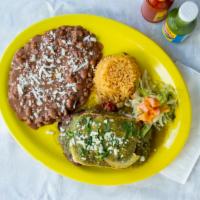 Bistec Los Agaves · Broiled steak topped with refried beans, green sauce, and melted cheese