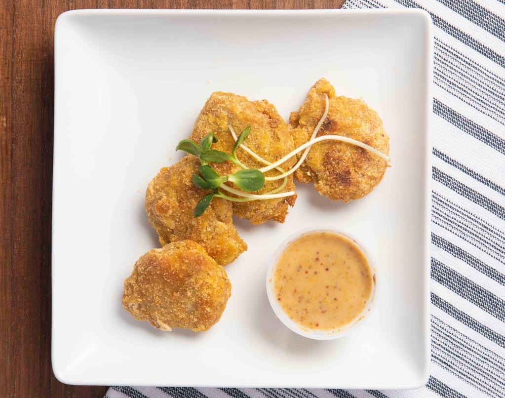 Chick'N Nuggets · Gluten free. Crispy gluten-free chick'n nuggets breaded with cornmeal, oven baked to a golden brown perfection served with a delicious maple mustard dipping sauce.