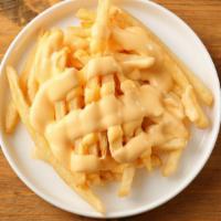 Cheese Fries · Golden crispy fries seasoned and fried to perfection. Topped with melted cheese.