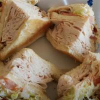 Turkey Club · Turkey breast, bacon, lettuce and tomato on white bread
Served with a side of pickle and pot...