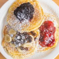 Pancakes · 3 fluffy buttermilk pancakes.
Fresh fruit and butter on top