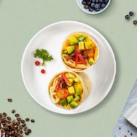 Easy Avocado Burrito · Avocado, eggs, tater tots, cheddar cheese, tomatoes and caramelized onions wrapped in a flou...