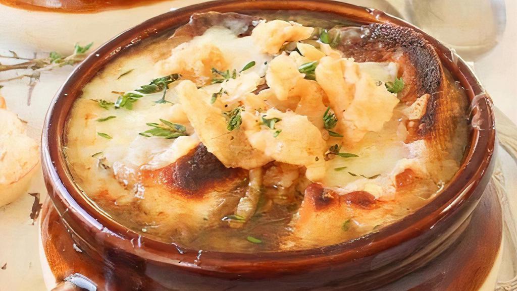 French Onion Soup · Bowl of French Onion Soup topped with mozzarella cheese baked to perfection.