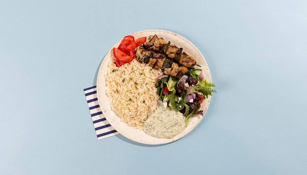 Chicken Soulvaki Rice Platter · Grilled chicken skewers served with rice, salad, pita bread, and tzatziki.