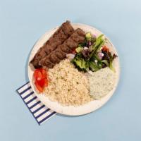 Ground Beef Kabob Rice Platter · Grilled ground beef kabob served with rice, salad, pita bread, and tzatziki.