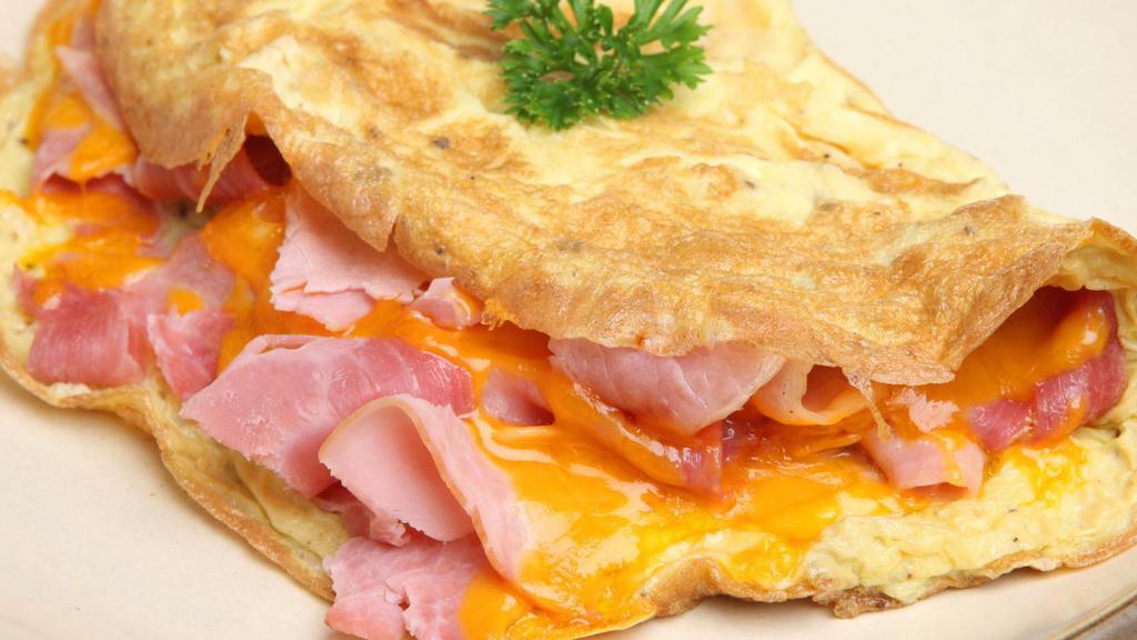 The Meat Lover Omelette · 3 freshly scrambled egg whites mixed with crispy bacon, pork roll, smoked sausage, country ham, and melted cheddar cheese. Served with your choice of bagel or croissant!