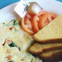 Health Kick Omelette · Egg whites, mushrooms, tomatoes, and basil. Served with toast and grits or home fries.