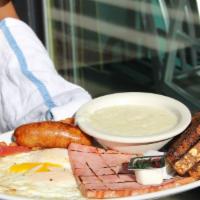 Breakfast Sampler · Two eggs any style with applewood smoked bacon, ham, and sausage. Served with toast and grit...