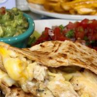 Chicken Quesadilla · Whole wheat tortilla with grilled chicken, cheddar cheese, guacamole, and salsa. Served with...
